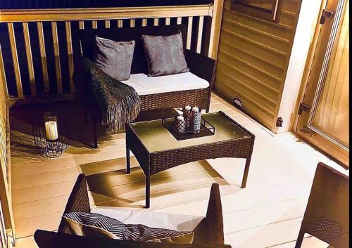 a balcony with a bed and a coffee table at The Fairways Hideaway - Northumberland in Newbiggin-by-the-Sea