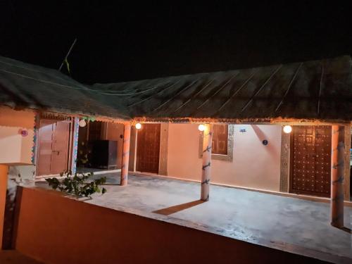 a view of a house at night with lights at Rann Kandhi in Dhordo