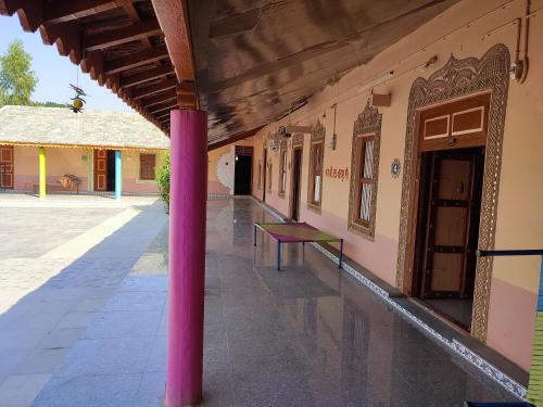 a pink pole in the middle of a building at Rann Kandhi in Dhordo