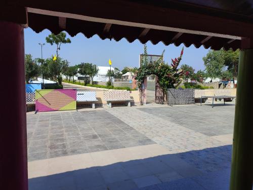 a view of a park with benches and a playground at Rann Kandhi in Dhordo