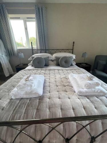 a bedroom with a large bed with towels on it at Eden’s Annexe in Cliburn