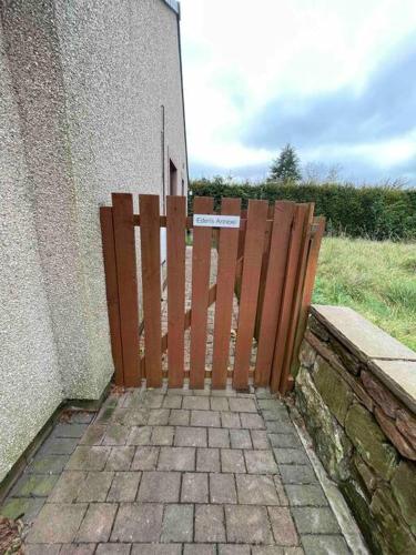 a wooden gate in front of a building at Eden’s Annexe in Cliburn