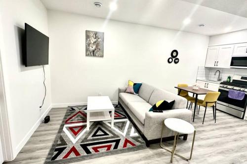 a living room with a couch and a table at The Cozy Nest in Calgary