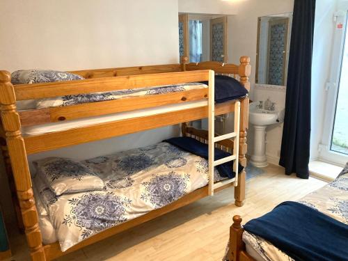 a bedroom with two bunk beds and a sink at Leigham House in Plymouth
