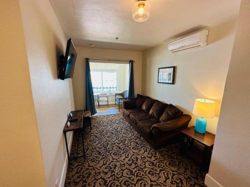 a living room with a couch and a television at The Edgewater in Avalon