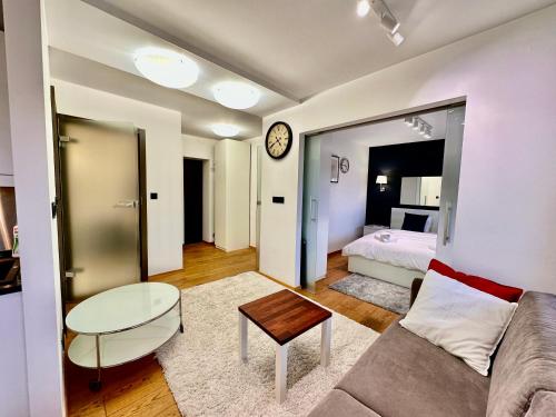 a living room with a couch and a table and a bed at FORUM 3 metro fast WiFi 400 Mbs TV HBO Disney+ in Warsaw