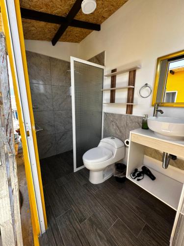 a bathroom with a toilet and a sink and a shower at CASA MARIN MANDIMBO in Oaxaca City