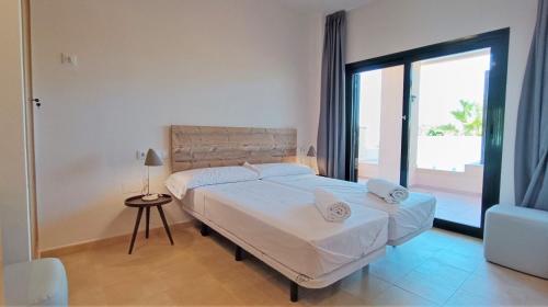 a bedroom with two beds and a large window at Casa Rust en Ruimte in Murcia