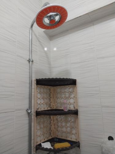 a shower with a red light in a bathroom at Beachside Chalet ,Sidi kerir in Abû Zeira