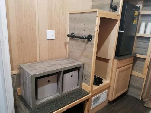 a small tv sitting on a shelf in a tiny house at Adirondack Country Living Tiny House Village in Canton