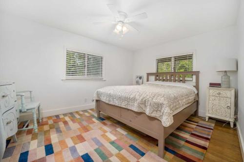 a bedroom with a bed and a ceiling fan at The Red House in Richmond