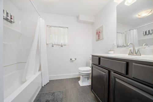 a bathroom with a toilet and a sink and a shower at The Red House in Richmond