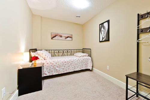 a small bedroom with a bed and a table at Home Away From Home in Calgary