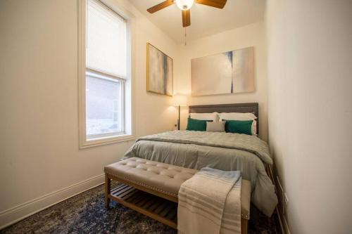 a bedroom with a bed and a ceiling fan at Pilsen Paradise l 3 miles to DT in Chicago