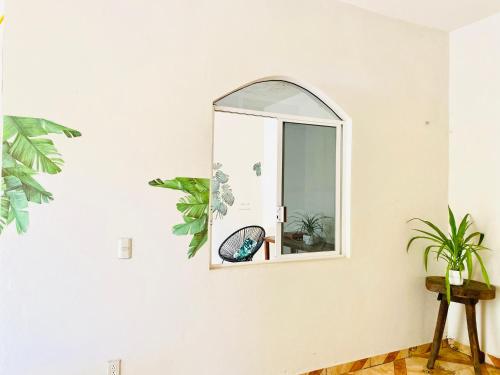 a mirror on a wall in a room at Casa Karma in Puerto Escondido