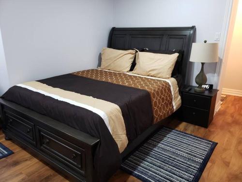 a bedroom with a large bed with a black headboard at Luxurious 1BR - 1BA Apt Modern Bright with free parking in Brampton