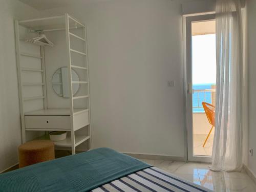 a bedroom with a bed and a dresser and a window at Beach Penthouse in Torrevieja