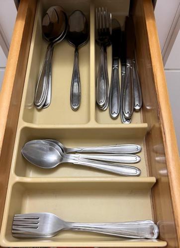 a drawer filled with silver utensils and spoons at Diver's Paradise Bonaire in Kralendijk