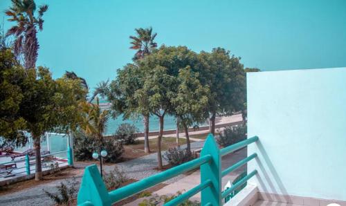 a balcony with a view of the beach and trees at Vila na Mágica Baía da Murdeira in Beirona