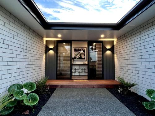 a skylight in a house with a walkway at Luxury Villa, Central, Golf and Cafés - By KOSH BNB in Hamilton