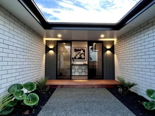 a skylight in a house with a walkway at Luxury Villa, Close to Town, Walks, Golf and Cafés in Hamilton