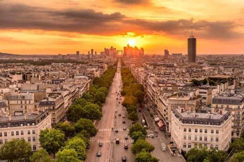 an aerial view of a city at sunset at Splendid Eiffel Tower & La Seine - 8 Beds in Paris