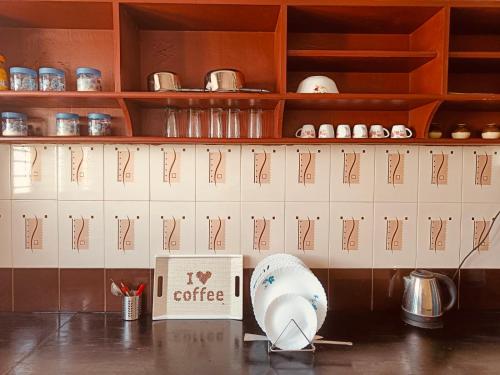 a kitchen counter with a coffee box and utensils at Citylight Family Homestay in Mysore