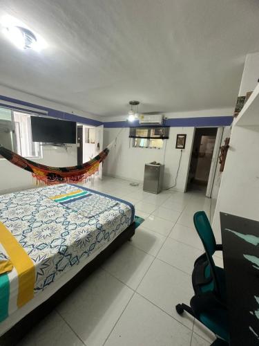 a bedroom with a bed and a hammock in it at Habitación Suite in Valledupar
