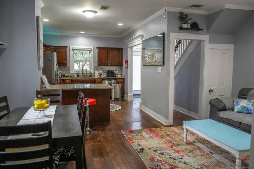 a kitchen and living room with a couch and a table at Historic Coastal Haven- Pet Friendly Fast Wi-Fi in Norfolk