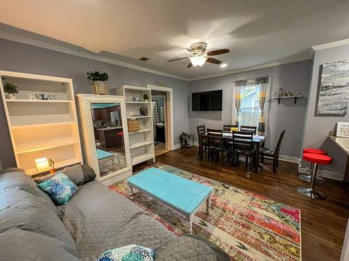 a living room with a couch and a dining room at Historic Coastal Haven- Pet Friendly Fast Wi-Fi in Norfolk