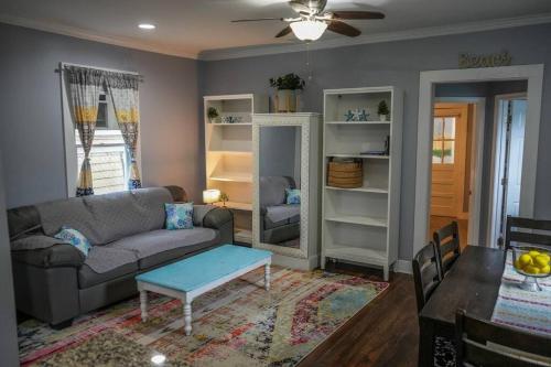 a living room with a couch and a table at Historic Coastal Haven- Pet Friendly Fast Wi-Fi in Norfolk