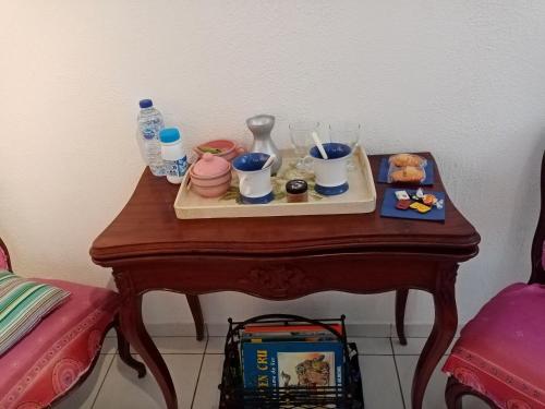 a wooden table with a tray of items on it at Au Calme in Verneuil d’Avre et d’Iton