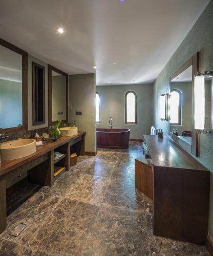 a large bathroom with two sinks and a tub at Sanctum Inle Resort in Nyaung Shwe