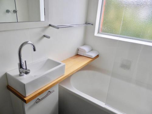 a bathroom with a sink and a bath tub at View Street Vista location parking and views in Sandy Bay