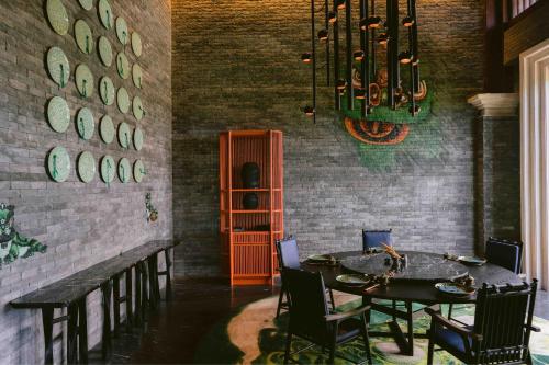 a dining room with a table and chairs and a chandelier at Marriott's Bali Nusa Dua Terrace in Nusa Dua