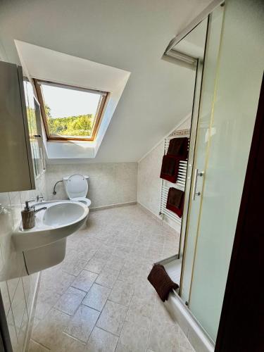 a bathroom with a sink and a toilet and a window at Pod Klíčem in Svor