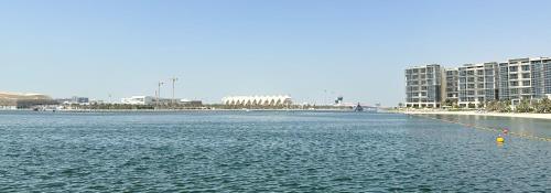 une grande masse d'eau avec des bâtiments en arrière-plan dans l'établissement Paradis De La Mer Al Zeina 507A1, à Abu Dhabi