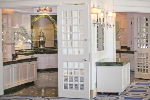 a bathroom with white cabinets and a large mirror at Westfields Marriott Washington Dulles in Chantilly