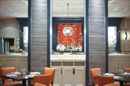a bar in a restaurant with tables and chairs at Westfields Marriott Washington Dulles in Chantilly