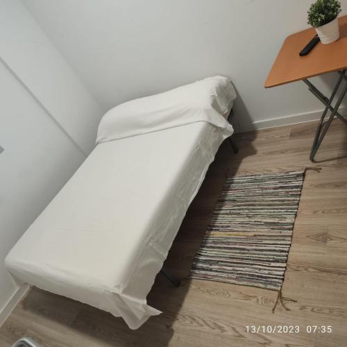 a bed with a sheet on the floor in a room at Casa particular Tatiana in Badalona