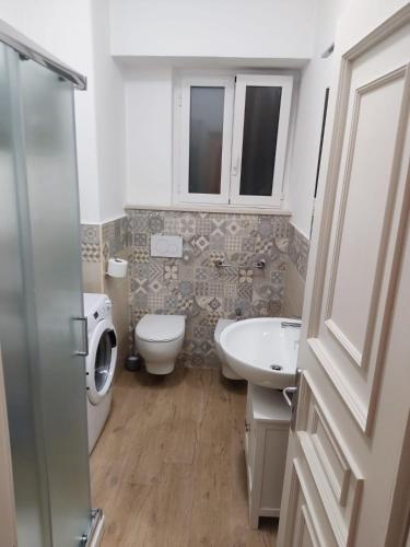 a bathroom with a toilet and a sink and a toilet istg at Holiday Home Ischia in Ischia