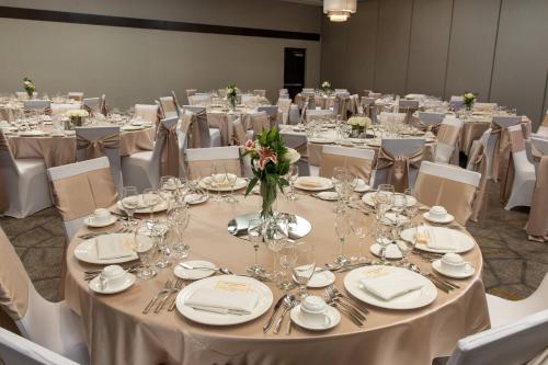 a room filled with tables and chairs with silverware at Courtyard by Marriott Lafayette in Lafayette