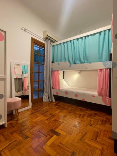a room with a bunk bed and a wooden floor at Morada City Hostel in Sao Paulo
