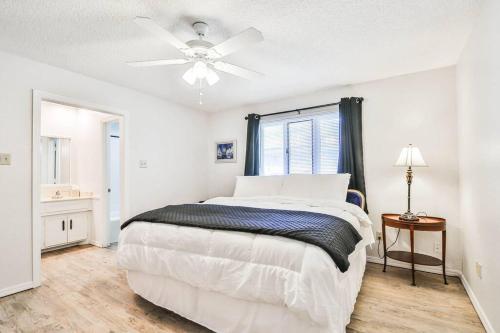 a white bedroom with a bed and a ceiling fan at Hot Tub, Privacy, sleeps 11 & TONS of Space! in Lubbock