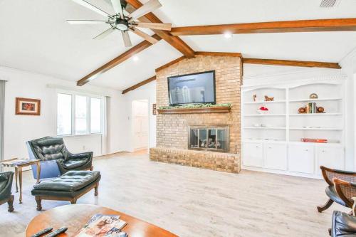a living room with a fireplace and a tv at Hot Tub, Privacy, sleeps 11 & TONS of Space! in Lubbock