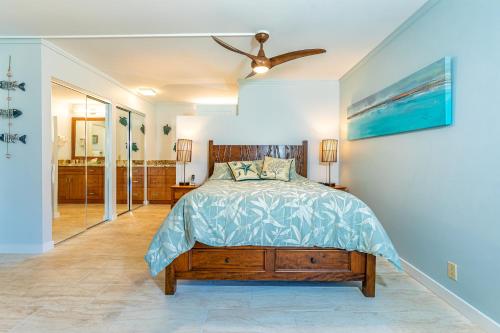 a bedroom with a bed and a ceiling fan at Kauhale Makai 122 in Kihei