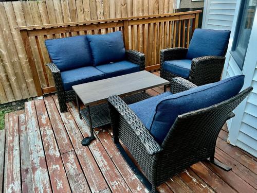 a patio with two chairs and a table on a deck at Crescent Heights Majesty in Calgary