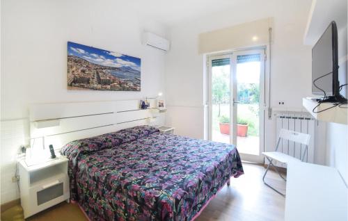 a small bedroom with a bed and a window at 2 Bedroom Cozy Apartment In Napoli in Naples