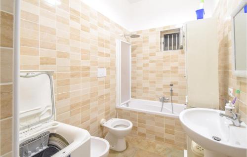 a bathroom with a toilet and a sink at 2 Bedroom Cozy Apartment In Napoli in Naples