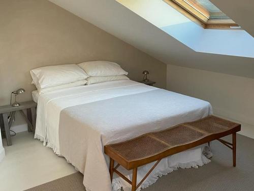 a bedroom with a white bed with a skylight at Maison Lugrin, 5 pièces, 7 personnes - FR-1-498-97 in Lugrin